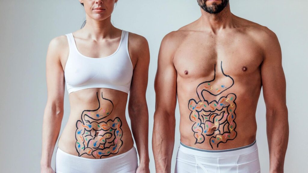 Uomo e donna con stomaco e intestino disegnati sul ventre
